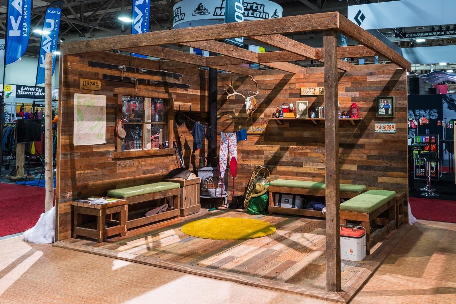 Custom reclaimed-timber cabin structure with an open beam roof and built-in benches